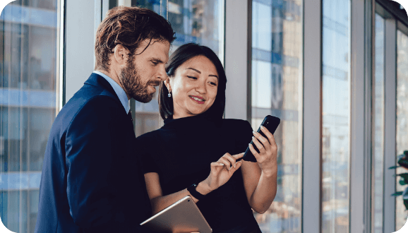 Man and woman looking in mobile device